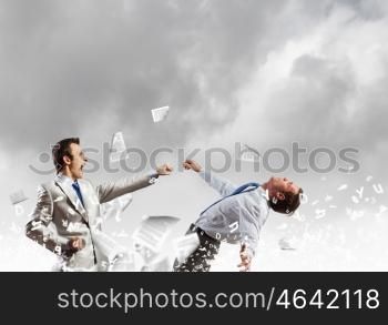 Two businesspeople in anger fighting with each other. Extreme quarrel