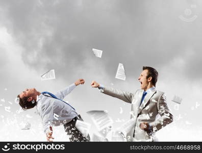 Two businesspeople in anger fighting with each other. Extreme quarrel