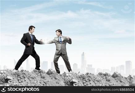 Two businesspeople in anger fighting with each other. Extreme quarrel