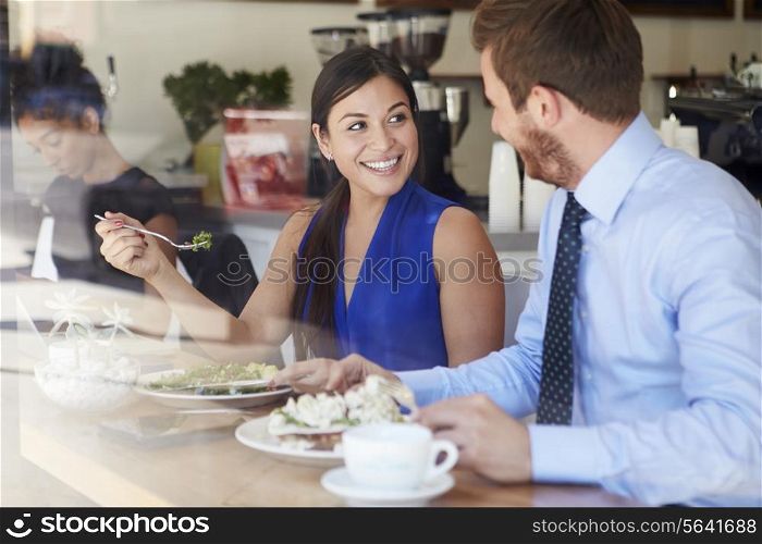 Two Businesspeople Meeting For Lunch In Coffee Shop