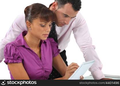 Two businesspeople reviewing notes