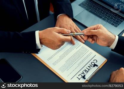 Two businesspeople sit across the desk as business deal is taking place. Corporate attorney giving a pen for client or partner to sign contract paper, sealing the deal with signature. Fervent. Hand giving pen to client or partner for signature. Fervent