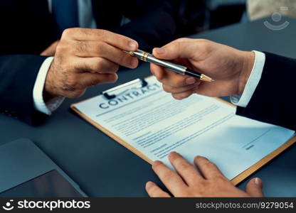 Two businesspeople sit across the desk as business deal is taking place. Corporate attorney giving a pen for client or partner to sign contract paper, sealing the deal with signature. Fervent. Hand giving pen to client or partner for signature. Fervent