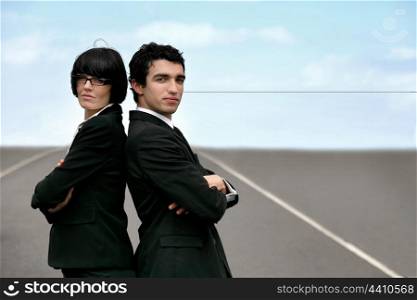 Two businesspeople stood on runway