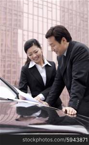 Two businesspeople working together outdoors