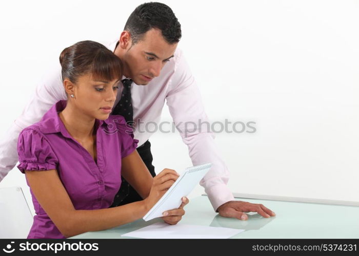 Two businesspeople writing down ideas