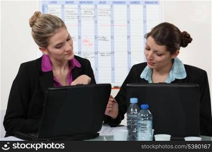 Two businesswoman working together