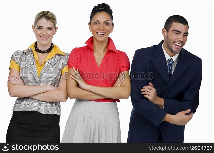 Two businesswomen and a businessman standing with their arms crossed and smiling