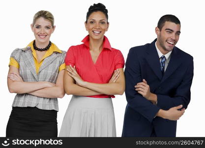 Two businesswomen and a businessman standing with their arms crossed and smiling