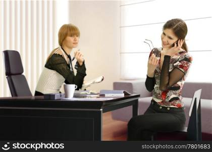 two businesswomen are working in the office
