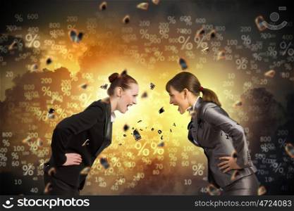Two businesswomen arguing. Image of two businesswomen in anger shouting at each other