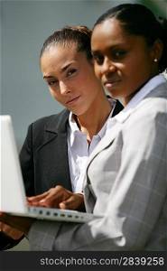 two businesswomen checking informations