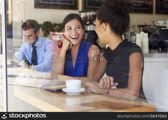 Two Businesswomen Meeting In Coffee Shop