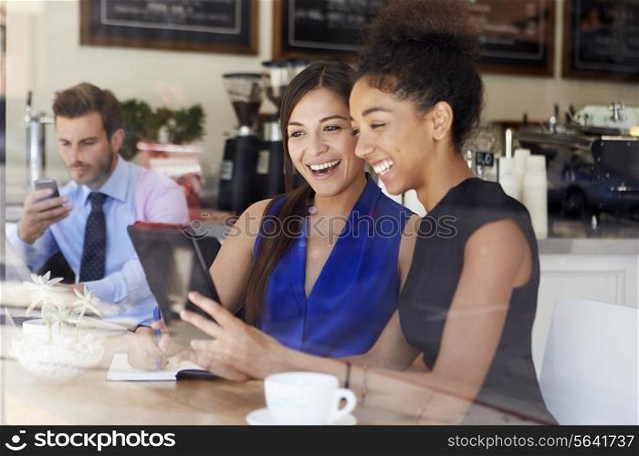 Two Businesswomen Meeting In Coffee Shop