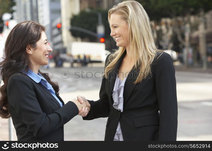 Two Businesswomen Shaking Hands Outside Office