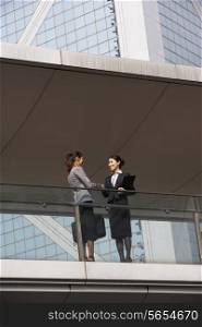 Two Businesswomen Shaking Hands Outside Office Building
