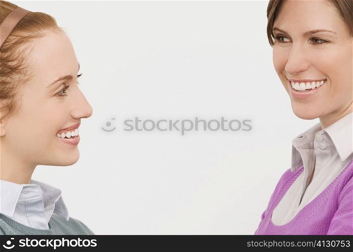 Two businesswomen smiling at each other