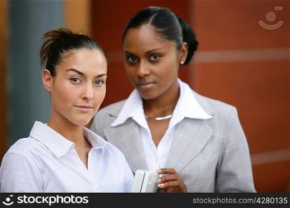 Two businesswomen stood outside office