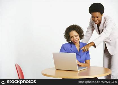 Two businesswomen using a laptop