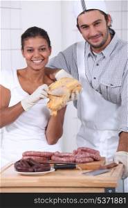 two butchers cutting fresh meat
