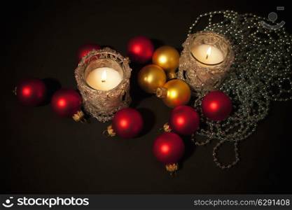 Two candles in glass candlesticks with christmas-tree decoration