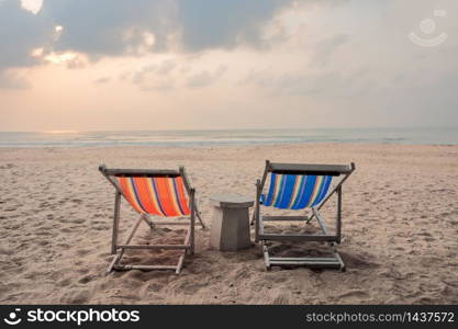 Two canvas chairs on the beach background at sunset in summer at Sai Kaew Beach, Thailand
