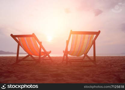 Two canvas chairs on the beach background at sunset in summer at Sai Kaew Beach, Thailand