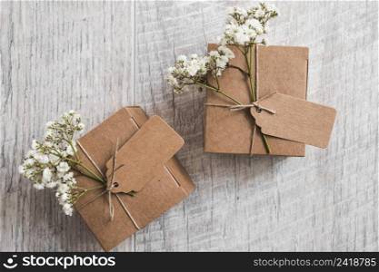 two cardboard boxes with tag baby s breath flowers wooden backdrop