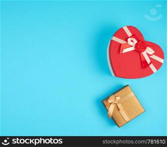 two cardboard holiday boxes on a blue background, top view, copy space