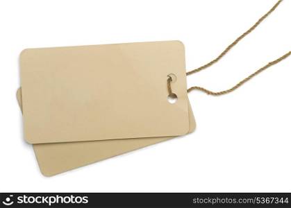 Two cardboard labels tied with brown string isolated on white
