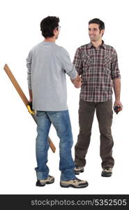 Two carpenters shaking hands