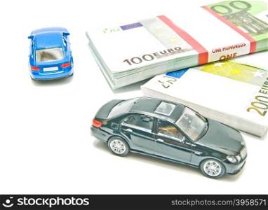two cars on euro notes on white background