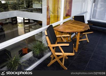 Two chairs and a table outside a house