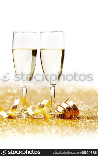 Two champagne glass on golden christmas glitter bokeh background. Two champagne glasses