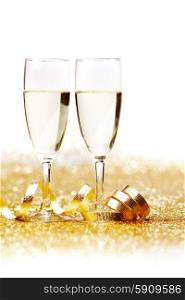 Two champagne glass on golden christmas glitter bokeh background. Two champagne glasses