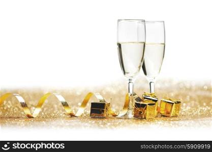 Two champagne glass on golden christmas glitter bokeh background. Two champagne glasses