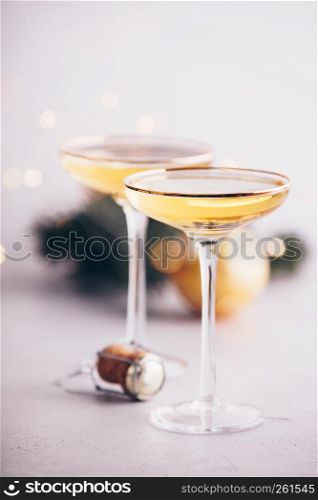 Two champagne glasses,cork and Christmas decorations on concrete background. Two champagne glasses, cork and Christmas decorations