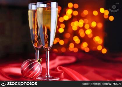 two champagne glasses on red silk