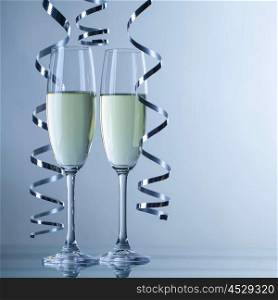 Two champagne glasses. Two champagne glasses and curly ribbon party concept