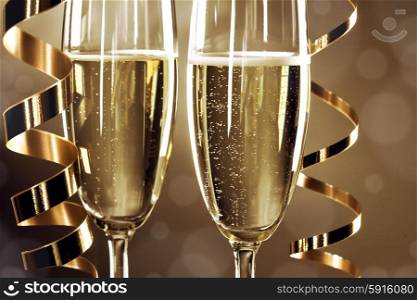 Two champagne glasses . Two champagne glasses and curly ribbons on dark background