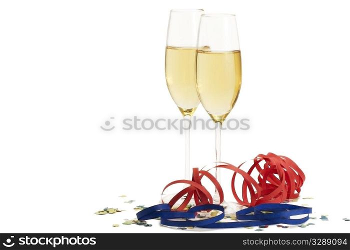 two champagne glasses with blow-outs and confetti. two champagne glasses with blow-outs and confetti on white background