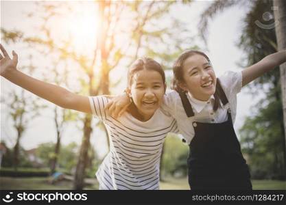 two cheerful asian teenager happiness emotion in public park