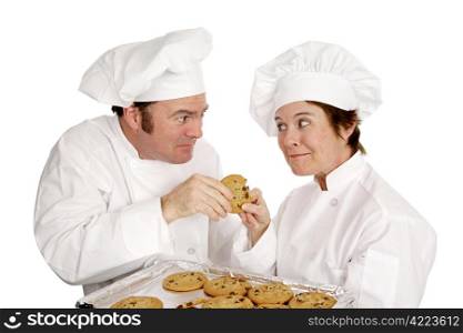 Two chefs fighting over a freshly baked chocolate chip cookie. Isolated on white.