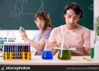 Two chemists students in classroom 