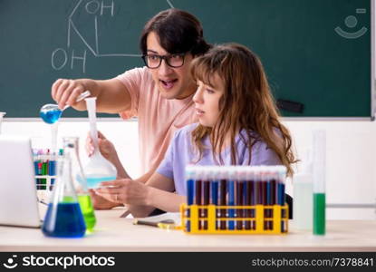 Two chemists students in classroom 