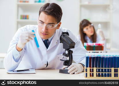 Two chemists working in lab experimenting