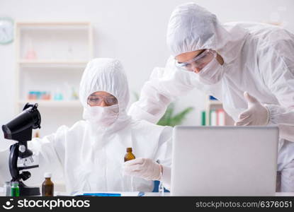 Two chemists working in the lab