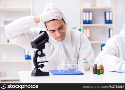 Two chemists working in the lab