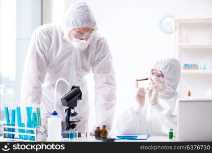 Two chemists working in the lab