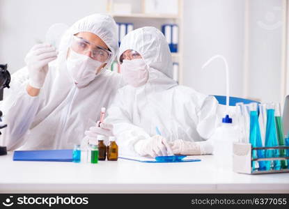 Two chemists working in the lab